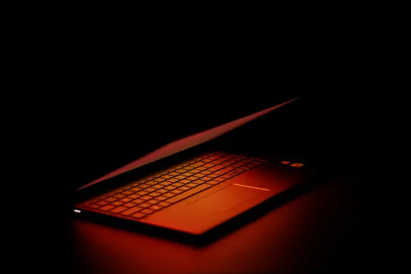 A laptop in a dark room